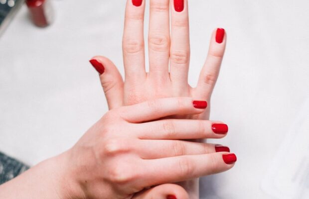 person with red nail polish